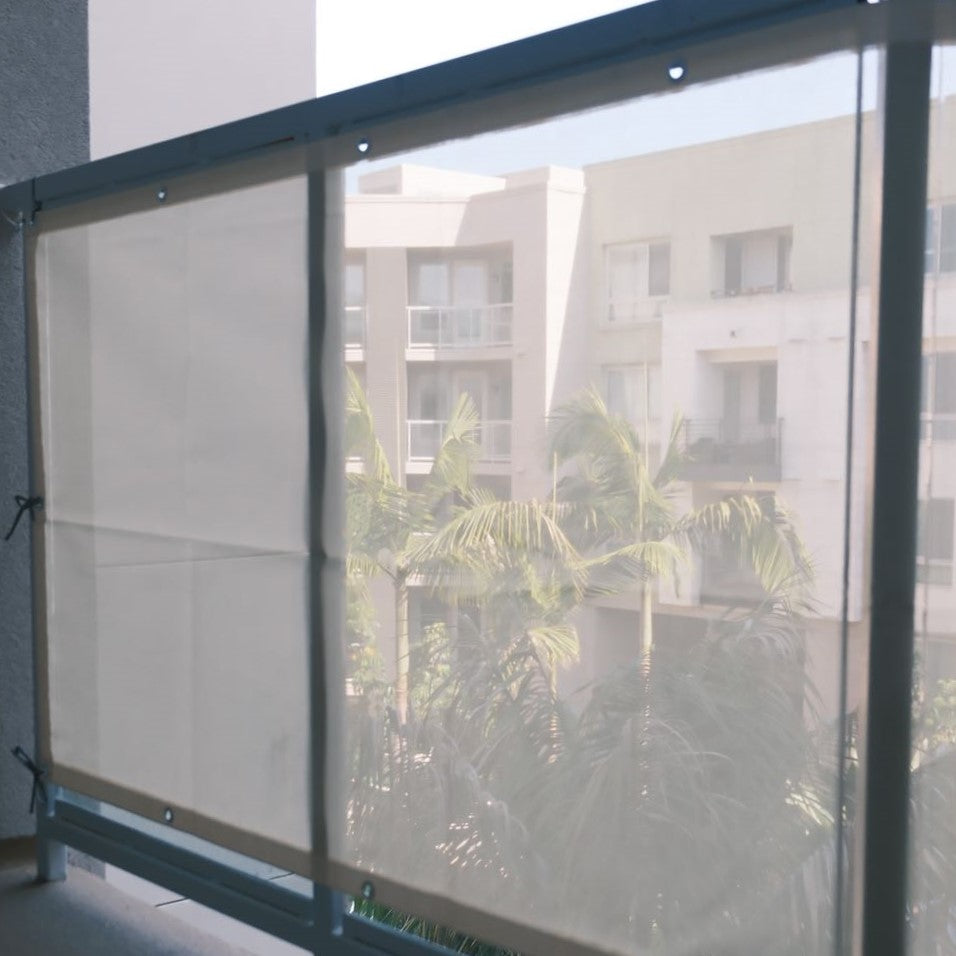 Man in cowboy hat reads book on balcony with privacy fence screen